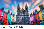 Colorful buildings surround a historic cathedral at sunset in an Irish town. Стоковое AI-изображение, AI-художник Сергей Толмачёв / Фотобанк Лори