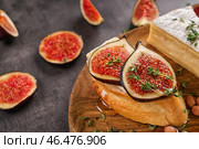 Вкусный бутерброд со спелым инжиром и сыром бри на деревянной тарелке, крупным планом. Стоковое фото, фотограф Pixel_shot / Фотобанк Лори