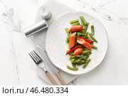 Тарелка с вкусной колбасой, стручковой фасолью и перцем чили на светлом фоне. Стоковое фото, фотограф Pixel_shot / Фотобанк Лори