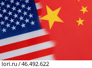 The flag of the United States and China with portraits of the dollar and the yuan. Стоковое фото, фотограф Igor Skripachev / Фотобанк Лори