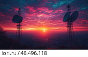 A stunning sunset over a city, painting the sky in shades of red, pink, purple and orange. In the center of the horizon, the sun is sinking below the horizon, bathing the surrounding landscape in a warm light. In the foreground, two massive radio telescopes or communication antennas rise, creating an impressive silhouette against the fiery sky. Below, the night city with twinkling lights stretches out, creating an atmosphere of technological progress and urban romance. Стоковое AI-изображение, AI-художник Анна Кривицкая / Фотобанк Лори