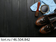 Лакированные кожаные туфли, ткань, щетка и крем для обуви на черном деревянном фоне. Стоковое фото, фотограф Pixel_shot / Фотобанк Лори