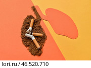 Бумажные легкие с сигаретами и табаком на оранжевом фоне. Стоковое фото, фотограф Pixel_shot / Фотобанк Лори