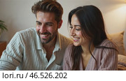 Man and woman are sitting on a bed and looking at a laptop. Стоковое AI-видео, аниматор Sergey Grishin / Фотобанк Лори