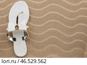 White flip flops with rhinestones on the wavy sand. Стоковое фото, фотограф Александр Собко / Фотобанк Лори