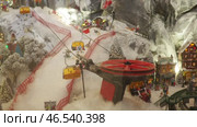 A charming miniature landscape showcases a ski resort with gondolas moving over snowy hills. Tiny skiers navigate slopes as festive decorations fill the scene, creating a magical winter atmosphere. Стоковое видео, видеограф Юлия Петровская / Фотобанк Лори
