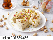 Тарелка вкусной халвы тахини с фисташками на светлом фоне. Стоковое фото, фотограф Pixel_shot / Фотобанк Лори