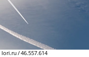 Two airplanes elegantly cross the vast sky above, leaving behind distinctive contrails that visually mark their path. Стоковое видео, видеограф PAv / Фотобанк Лори