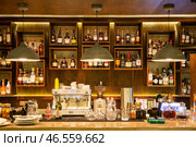 Variety of bottles with alcohol and cocktails on shelves behind the bar (2024 год). Редакционное фото, фотограф Евгений Ткачёв / Фотобанк Лори