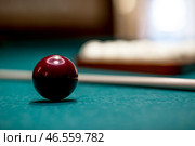 Russian billiards. Red and white balls are lying on a green billiard table. Spending time at home playing a hobby sports game. Стоковое фото, фотограф Photojuli / Фотобанк Лори