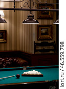 Russian billiards. Red and white balls are lying on a green billiard table. Spending time at home playing a hobby sports game. Стоковое фото, фотограф Photojuli / Фотобанк Лори