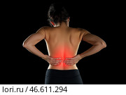 Back pain, kidney inflammation, woman suffering from backache on black background. Стоковое AI-изображение, AI-художник Станислав Тарко / Фотобанк Лори