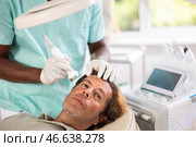 Man undergoing anti-aging ultrasonic phonophoresis procedure on face. Стоковое фото, фотограф Яков Филимонов / Фотобанк Лори