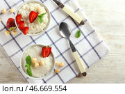 Вкусный рисовый пудинг с клубникой и фундуком в мисках на столе. Стоковое фото, фотограф Pixel_shot / Фотобанк Лори