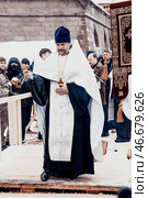 Saint Petersburg, Russia, 19 January 2022, Priest consecrate water, hold cross. Редакционное фото, фотограф Spirit River / Фотобанк Лори