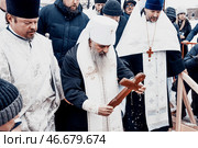 Saint Petersburg, Russia, 19 January 2022, Priest consecrate water, hold cross. Редакционное фото, фотограф Spirit River / Фотобанк Лори