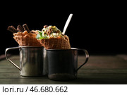 Металлические чашки с вафельными рожками и вкусным мороженым на деревянном столе. Стоковое фото, фотограф Pixel_shot / Фотобанк Лори