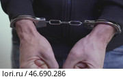 Male Hands Restrained in Steel Cuffs. Стоковое видео, видеограф Илья Шаматура / Фотобанк Лори