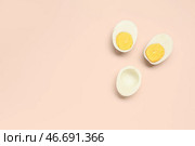 Половинки вкусных отваренных яиц на розовом фоне. Стоковое фото, фотограф Pixel_shot / Фотобанк Лори