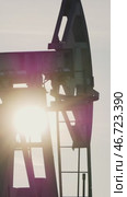 Oil pump jack is extracting crude oil at sunset. Стоковое видео, видеограф Константин Шишкин / Фотобанк Лори