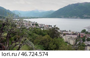 Озеро Маджоре и город Локарно в пасмурный день. Швейцария. Май. Lake Maggiore and the city of Locarno on a cloudy day. Switzerland. May. Стоковое видео, видеограф Горшков Александр / Фотобанк Лори