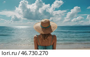 A woman on vacation, sitting in a swimsuit and a wide-brimmed straw hat on the beach on a sunny day and looking at the sea. Стоковое AI-изображение, AI-художник Photojuli / Фотобанк Лори