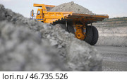 Heavy large transport in mining industry on background of open white multistage quarry. Стоковое фото, фотограф David Kashakhi / Фотобанк Лори
