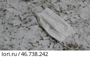 Medical mask is thrown to floor and trampled underfoot. Стоковое фото, фотограф David Kashakhi / Фотобанк Лори