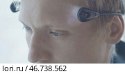 Close-up of man wearing flashlights shining on his head temples. Стоковое фото, фотограф David Kashakhi / Фотобанк Лори
