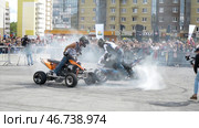 Professional riders on motorcycle transport perform tricks on site located in city for Moto festival. Редакционное фото, фотограф David Kashakhi / Фотобанк Лори