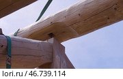Installation of wooden beams at construction the roof truss system of the house. Стоковое фото, фотограф David Kashakhi / Фотобанк Лори