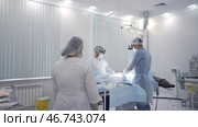Preparing patient for surgery and anesthesia in modern light operating room. Стоковое фото, фотограф David Kashakhi / Фотобанк Лори