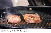 Beef steaks on the grill with flames. Стоковое фото, фотограф David Kashakhi / Фотобанк Лори