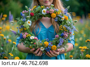 A beautiful summer wreath of wildflowers in the hands of a girl. Summer spring time. Summer solstice background. The feast of Ivan Kupala. Стоковое AI-изображение, AI-художник Photojuli / Фотобанк Лори