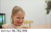 Child tasting a sour lemon and reacting with a playful facial expression. Стоковое видео, видеограф Дмитрий Наумов / Фотобанк Лори