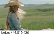 Blonde girl in a cowboy hat riding a horse in the middle of a field. AI-generated item. Стоковое AI-видео, аниматор Алексей Кузнецов / Фотобанк Лори