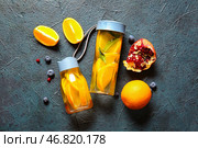 Спортивные бутылки с водой с добавлением апельсиновых ломтиков на голубом фоне. Стоковое фото, фотограф Pixel_shot / Фотобанк Лори