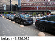 Belarus, Minsk - 13 july, 2024: Cars are parked in front of DoubleTree by Hilton building. Редакционное фото, фотограф Аксенова Вера / Фотобанк Лори