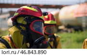Firefighters. Clip. Two masked men who conduct exercises with a hose and water with special equipment and in a special uniform. Стоковое фото, фотограф Данил Руденко / Фотобанк Лори