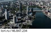 Tall buildings with blue windows taken from a drone. Stock footage. A magnificent landscape of a big city with beautiful houses and parks around the river. Стоковое фото, фотограф Данил Руденко / Фотобанк Лори