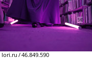Women are mysteriously walking in library. Stock footage. Secret sorority in night library. Elegant women mysteriously gather in night library with flashing light. Стоковое фото, фотограф Данил Руденко / Фотобанк Лори