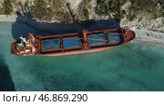 Aerial top view of an empty, red barge moored near the beautiful blue sea shore. Стоковое фото, фотограф David Kashakhi / Фотобанк Лори