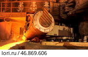 Close up for aluminum melting furnace in a foundry moving backwards, heavy metallurgy concept. Стоковое фото, фотограф David Kashakhi / Фотобанк Лори