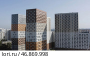 Aerial view of high rise buildings with bright colorful facade, concept of accommodation and urbanization. Стоковое фото, фотограф David Kashakhi / Фотобанк Лори