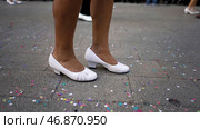 Close up for legs of men and women in white shoes dancing in the street during the national holiday. Стоковое фото, фотограф David Kashakhi / Фотобанк Лори