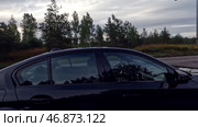 Машина приехала на зеленую стоянку в лесу в Финляндии рано утром. Май. The car arrived at a green parking in the forest in Finland early in the morning. May. Редакционное видео, видеограф Горшков Александр / Фотобанк Лори