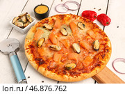 Доска с вкусной пиццей из морепродуктов на светлом деревянном фоне. Стоковое фото, фотограф Pixel_shot / Фотобанк Лори
