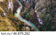 Aerial beautiful mountain stream, river surrounded by green trees with crystal clear waters winding through the mountains. Стоковое фото, фотограф David Kashakhi / Фотобанк Лори