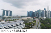 Singapore - 25 September 2018: Singapore city skyline along Singapore River, beautiful green grass and the road. Редакционное фото, фотограф David Kashakhi / Фотобанк Лори