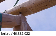 Installation of wooden beams at construction the roof truss system of the house. Стоковое фото, фотограф David Kashakhi / Фотобанк Лори